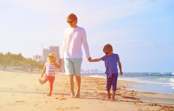 Vader en twee kinderen op strand — Stockfoto