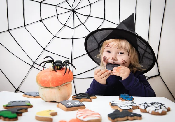 little girl eating cookies on halloween, kids trick or treating