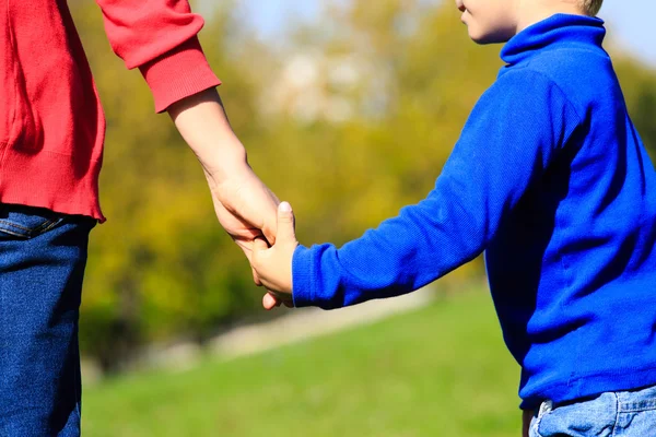 Mother holding hand of her son — Stock Photo, Image