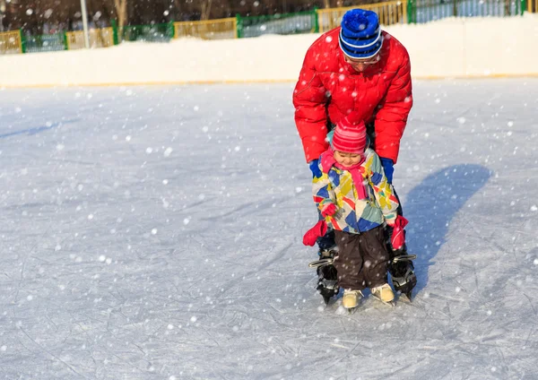 Pai e criança aprendendo a patinar no inverno — Fotografia de Stock