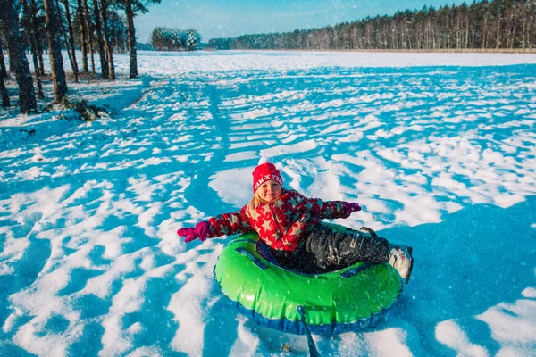 Mutlu küçük kız kış karında kayıyor, çocuk dışarıda eğleniyor. — Stok fotoğraf