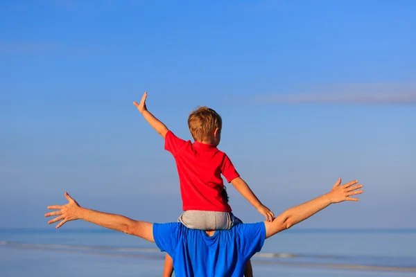 Gelukkig vader en zoon spelen op zee strand — Stockfoto