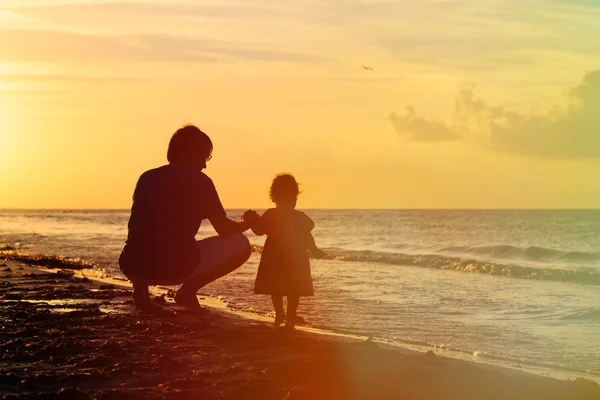 Pappa och lilla dotter silhuetter i solnedgången — Stockfoto