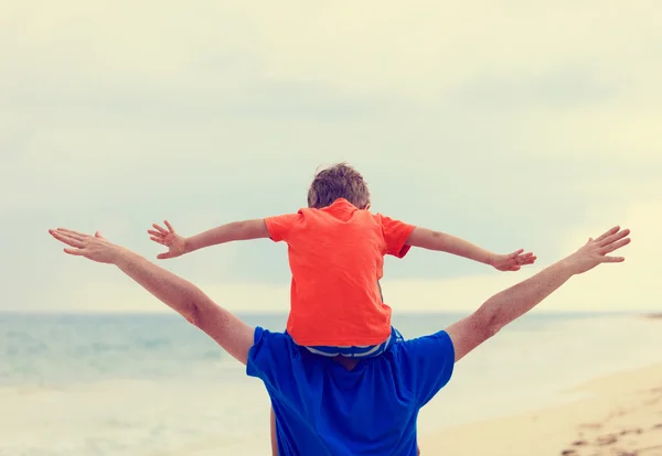 Feliz pai e filho brincando na praia do mar — Fotografia de Stock