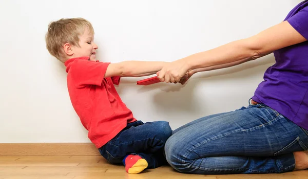 Computer addiction, parent taking out touch pad from child — Stock Photo, Image