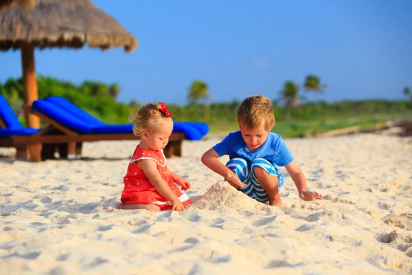 Niños jugando con arena en la playa de verano —  Fotos de Stock