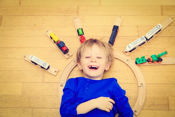 Child playing with trains indoor — Stock Photo, Image