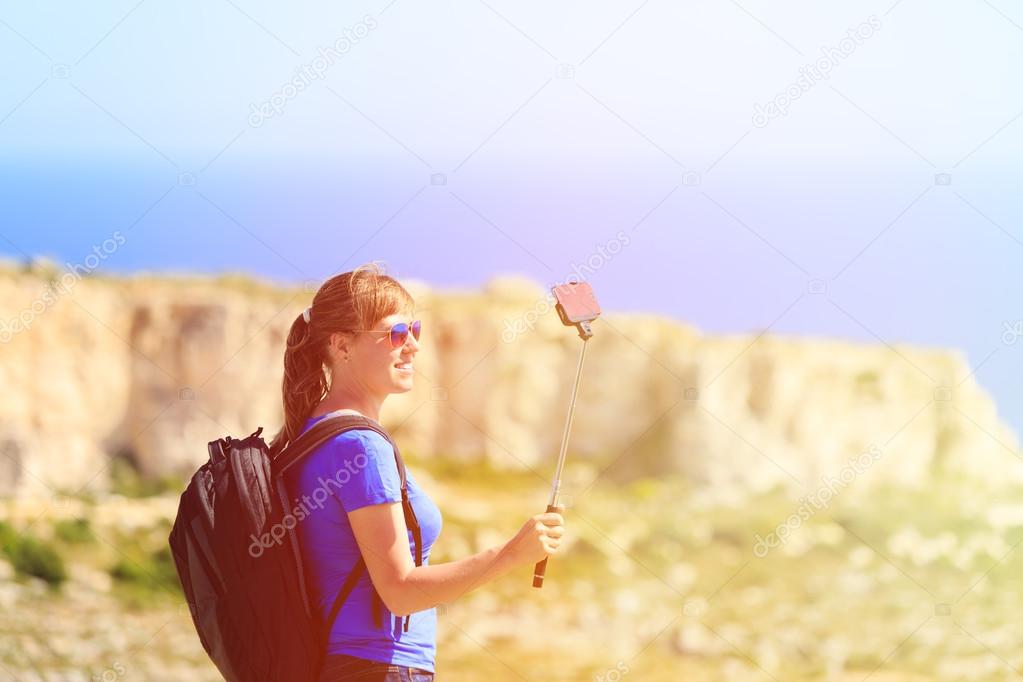 tourist making selfie photo on mountains travel