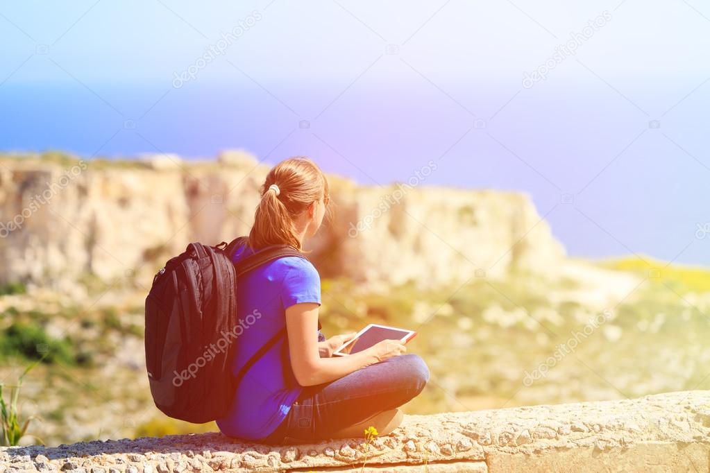 tourist looking at touch pad on mountains travel