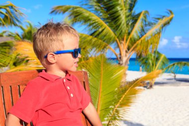 little boy waiting in cafe on tropical resort