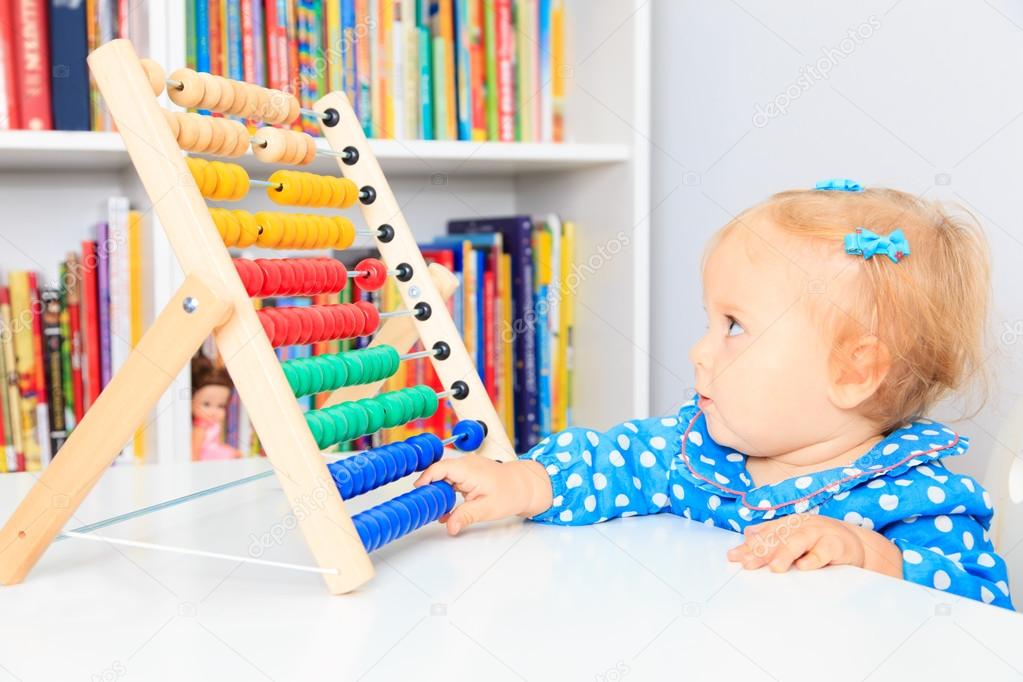 little girl playing with abacus