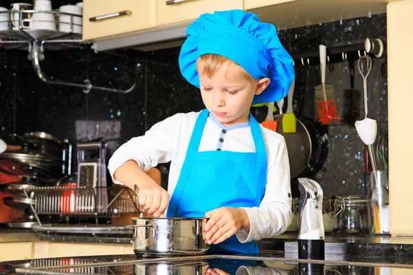 Little boy cooking in kitchen interior — Stock Photo, Image