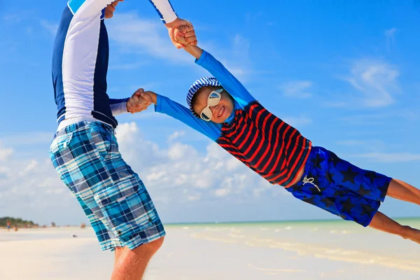 Father and son playing on the beach Royalty Free Stock Photos