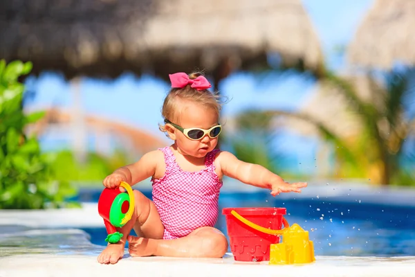 Gadis kecil bermain di kolam renang di pantai tropis — Stok Foto