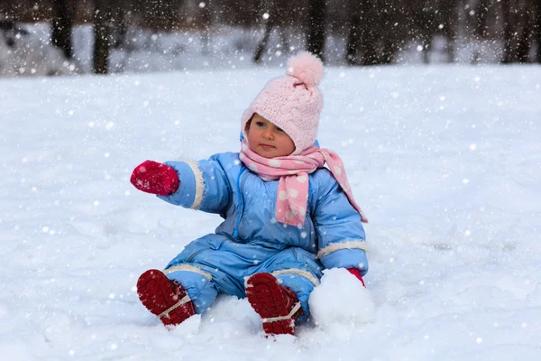 Aranyos kis tipegő lány téli hó — Stock Fotó