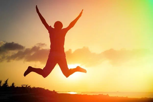 Silhouette of man jumping on beach — Stock Photo, Image