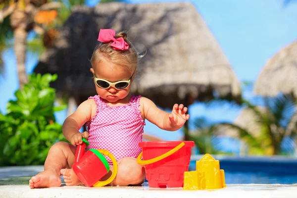 Cute toddler girl playing in swimming pool — Stock Photo, Image
