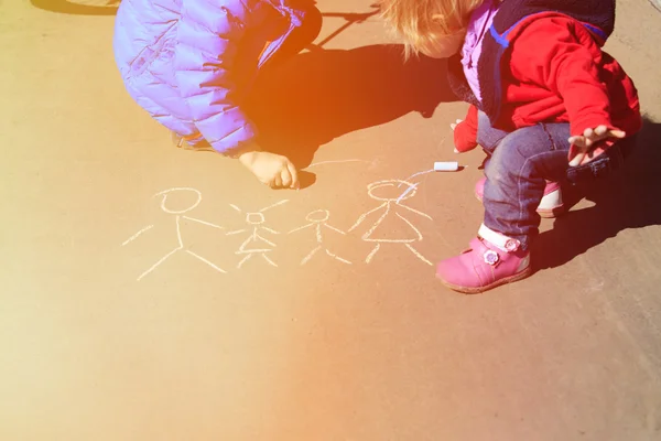 Little boy and girl drawing family with chalk on asphalt — Stock Photo, Image