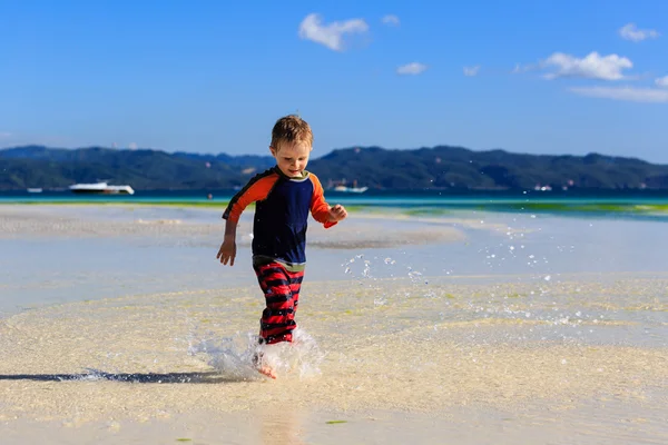 Mały chłopiec biegną na piaszczystej plaży — Zdjęcie stockowe