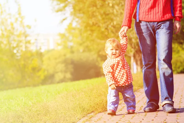 First steps of cute little girl in autumn park — Stock Photo, Image