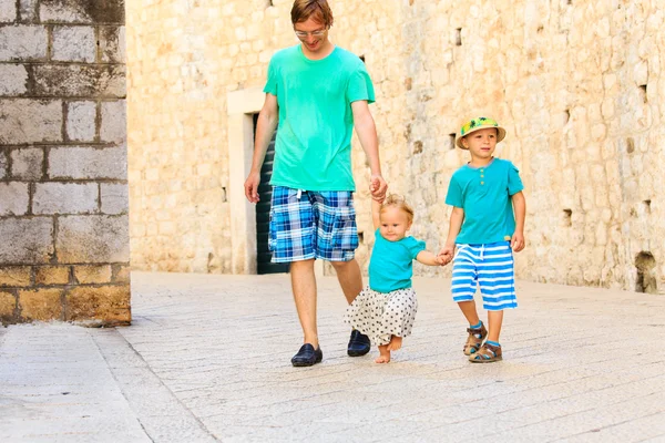Отец с детьми, гуляющими в отпуске в Европе — стоковое фото