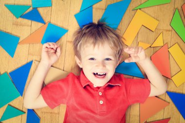 ahşap zemin üzerinde bulmaca oyuncaklarla mutlu küçük çocuk