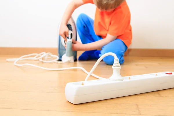 Child playing with electricity, kids safety — Stock Photo, Image