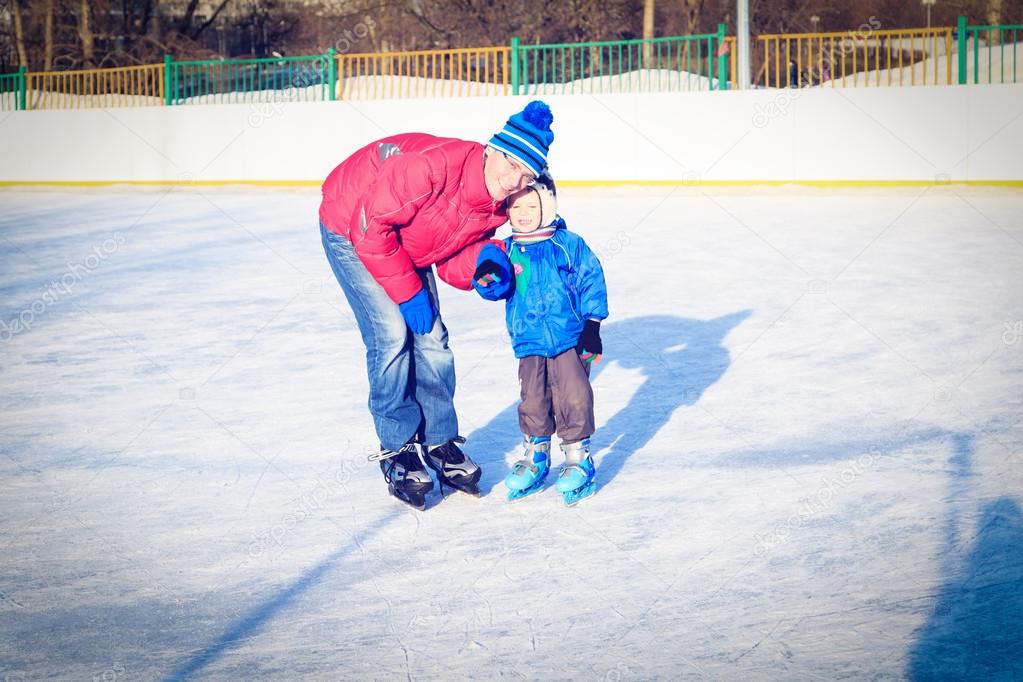 little boy skating with parent