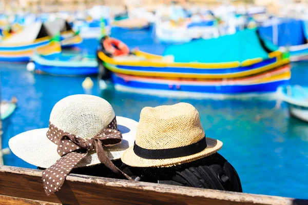 Two hats with traditional maltese boats on background — Stock Photo, Image