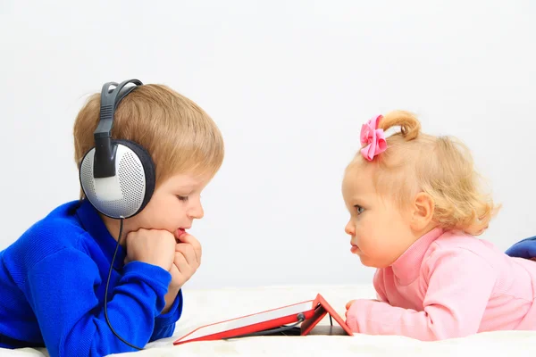 Little boy and toddler girl with headset using touch pad — Stock Photo, Image