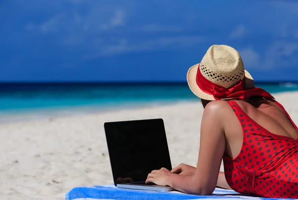 woman with laptop on tropical vacation