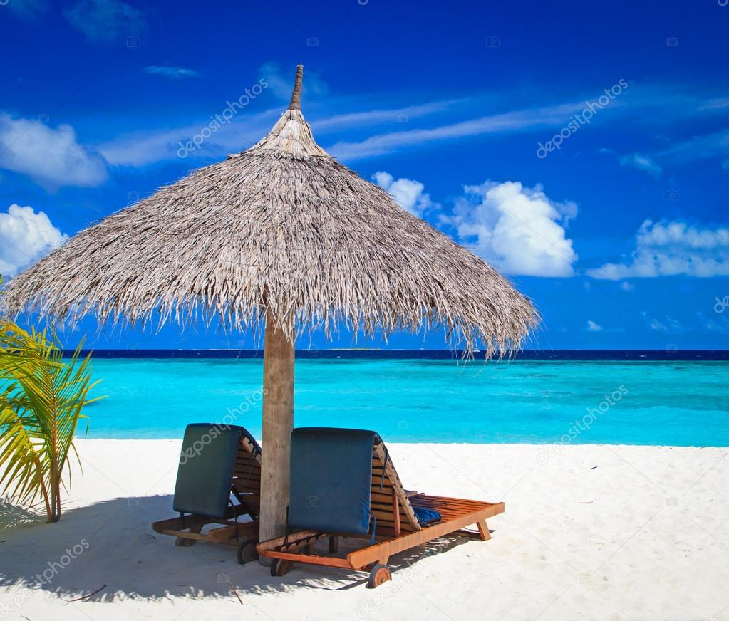 Beach chairs on tropical beach