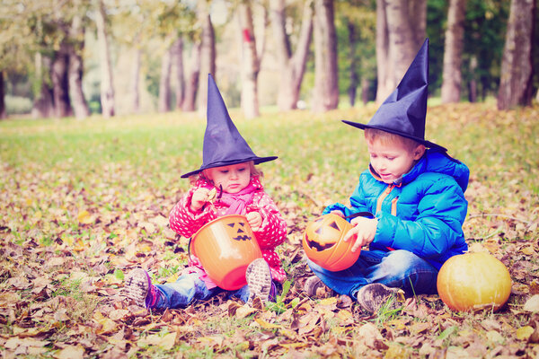 kids in halloween costume play at autumn park