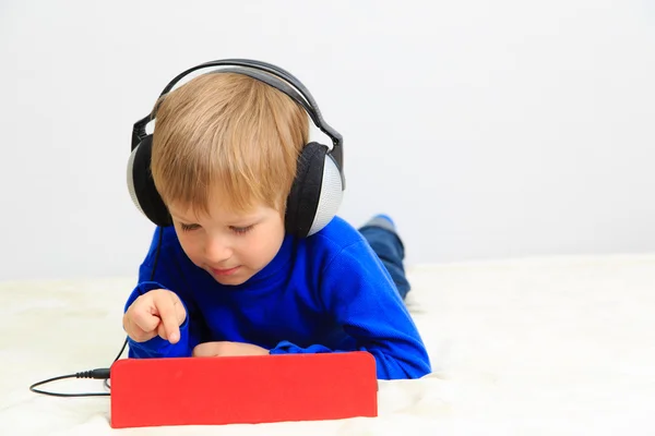 Little boy with headset using touch pad — Stock Photo, Image