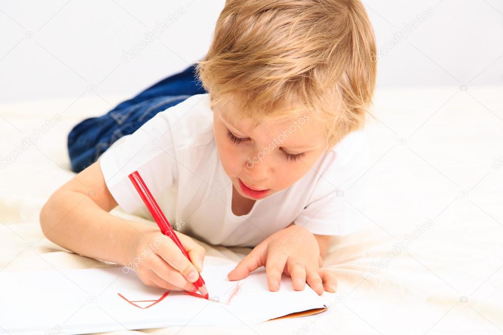 little boy learning to write letters