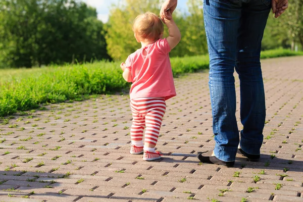 Meisje maken van eerste stappen in het park — Stockfoto