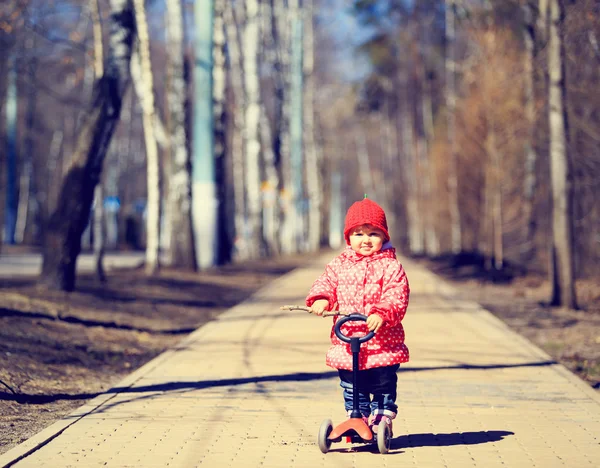 Carino bambina equitazione scooter in città — Foto Stock