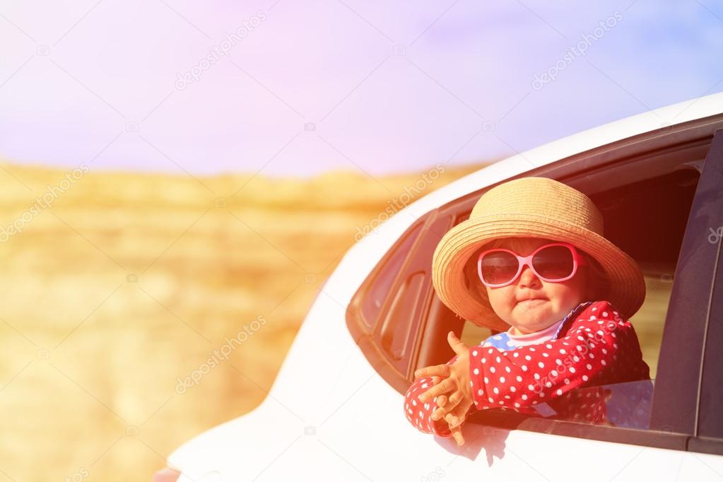 cute little girl travel by car in mountains