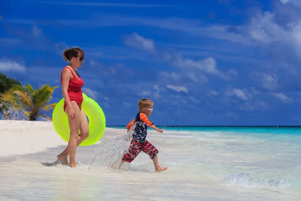 Mutter und Sohn gehen am Strand schwimmen — Stockfoto