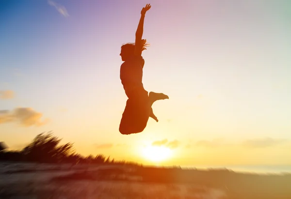 Silhouette of woman jumping on sunset — Stock Photo, Image