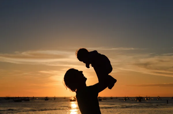 Padre e figlioletta siluette sulla spiaggia al tramonto — Foto Stock