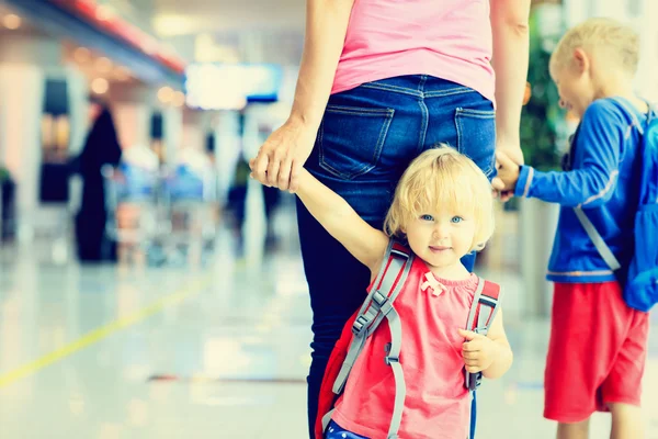 Mother and two kids walking in the airport — Stock Photo, Image