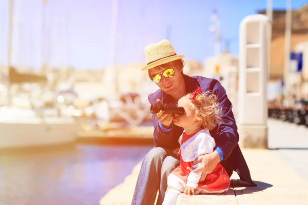 Father and little daughter looking at binoculars in the port — Stock Photo, Image