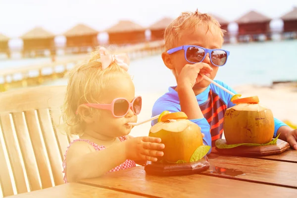 Malý chlapec a batole dívka pití kokosový koktejl beach Resort — Stock fotografie