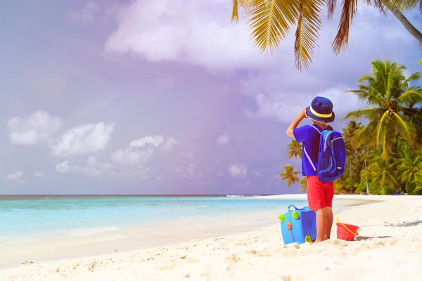 Küçük çocuk seyahat bavul ve dürbün ile sahilde — Stok fotoğraf