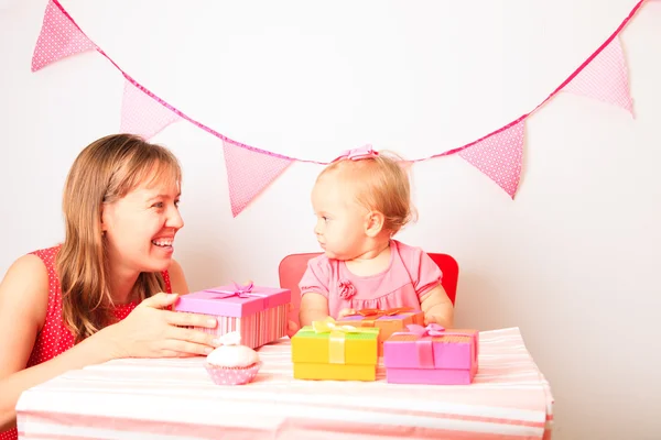 Mother giving presents to little daughter at birthday — Stock Photo, Image