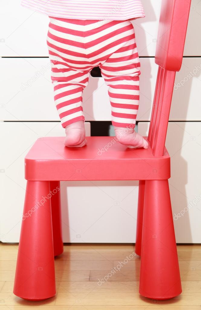 child feet on baby chair, kids home safety concept