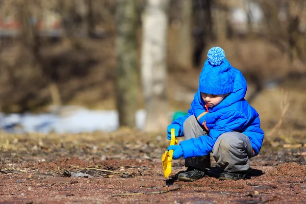 Little boy plaing in spring puddle outdoors — Stock Photo, Image