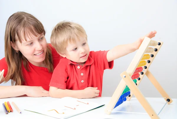 Moeder en zoon spelen met abacus — Stockfoto
