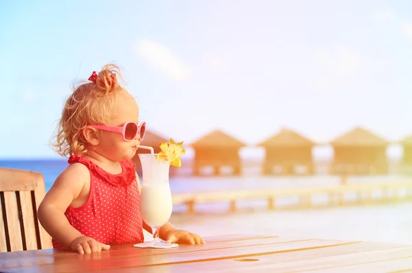 Roztomilá holčička pít koktejl na tropické pláži — Stock fotografie